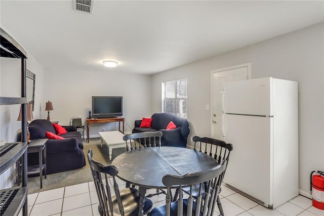 dining space with light tile floors