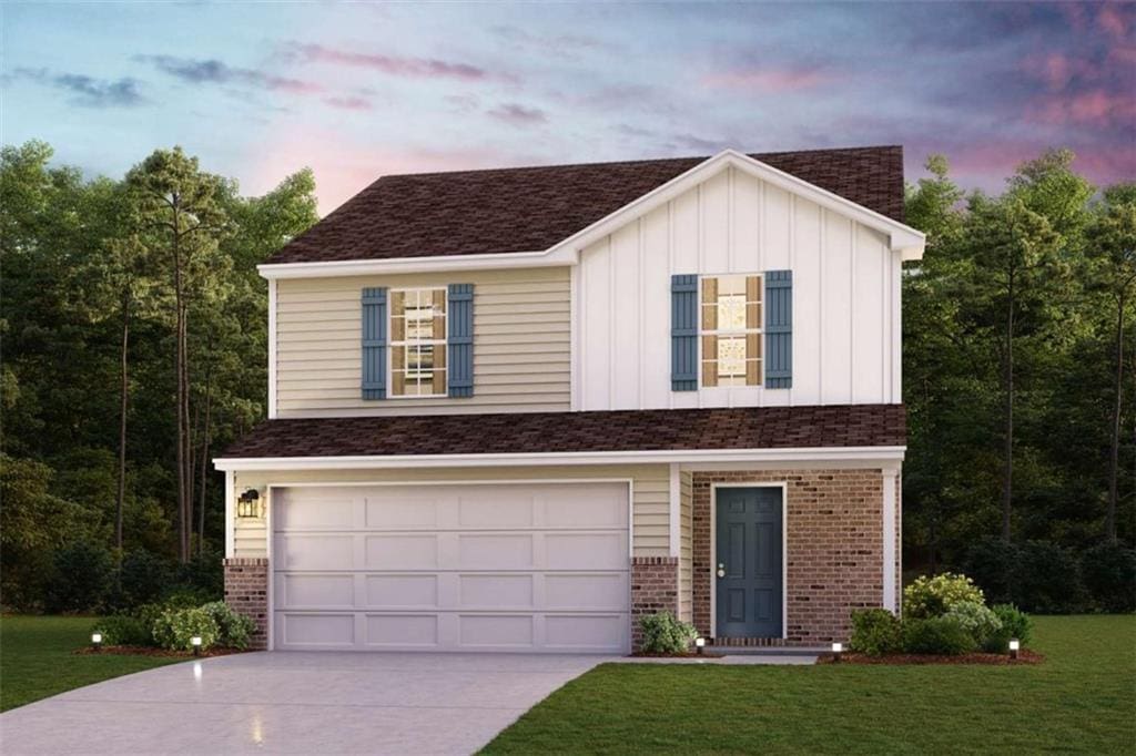 150 Pinehurst Ct, Dublin, GA 31021 - view of front of house with board and batten siding, concrete driveway, an attached garage, a lawn, and brick siding