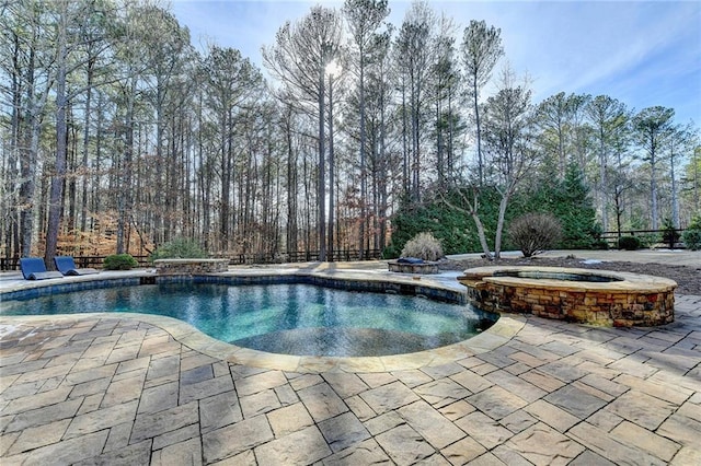 view of swimming pool with a patio and an in ground hot tub