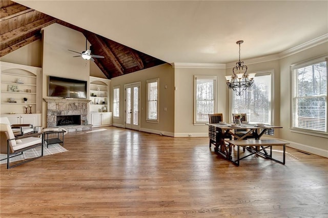 dining room featuring built in shelves, lofted ceiling with beams, wood ceiling, and hardwood / wood-style floors