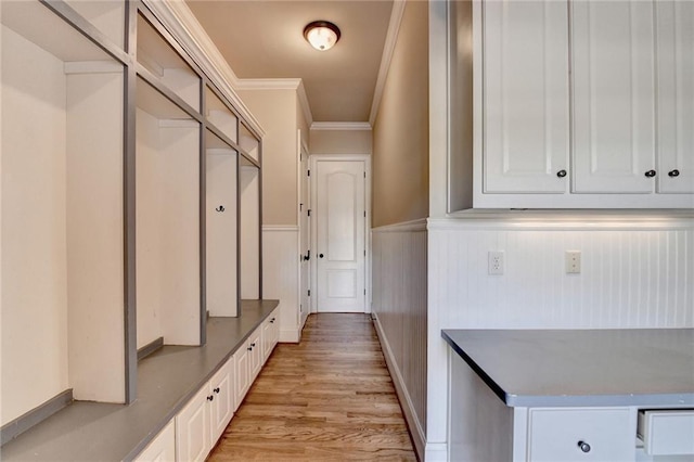 mudroom with ornamental molding and light hardwood / wood-style floors