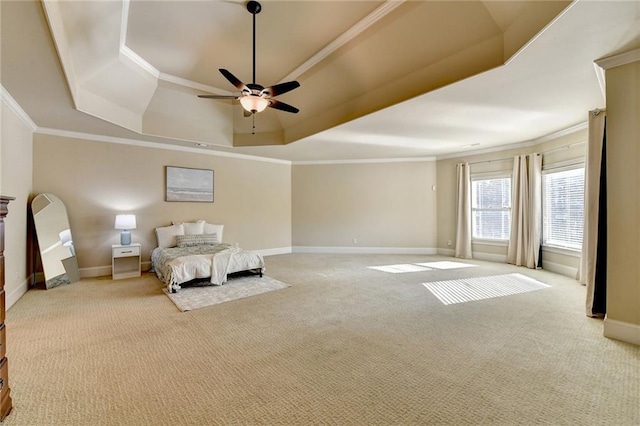 unfurnished bedroom with ceiling fan, light colored carpet, ornamental molding, and a tray ceiling