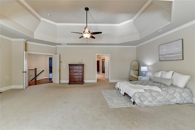 bedroom featuring ceiling fan, a tray ceiling, ornamental molding, and light colored carpet