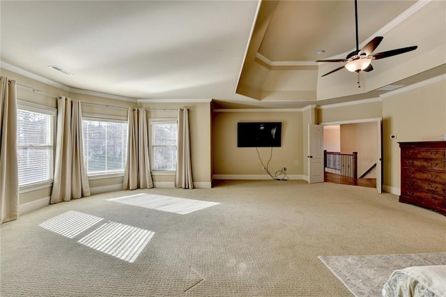 carpeted living room with ceiling fan, crown molding, and a tray ceiling