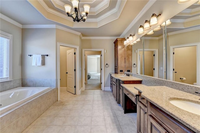 bathroom with vanity, a raised ceiling, a chandelier, and ornamental molding