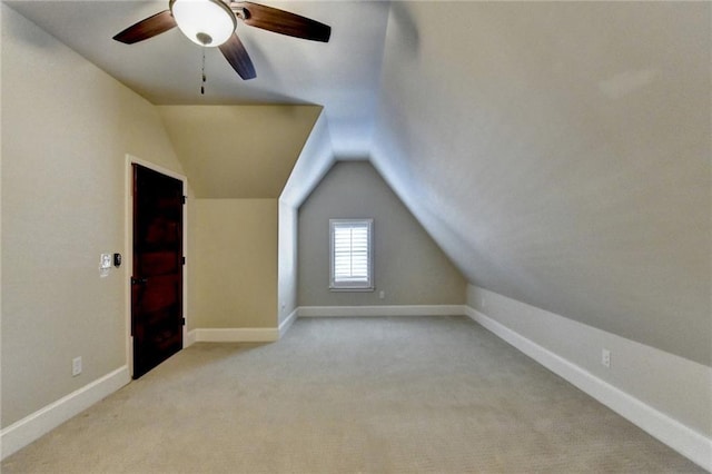 bonus room with lofted ceiling, light colored carpet, and ceiling fan