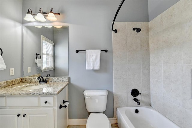 full bathroom with vanity, tiled shower / bath combo, and toilet