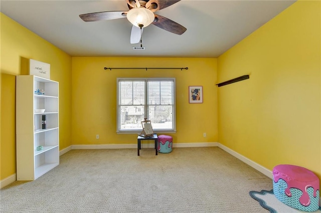 misc room featuring ceiling fan and light carpet