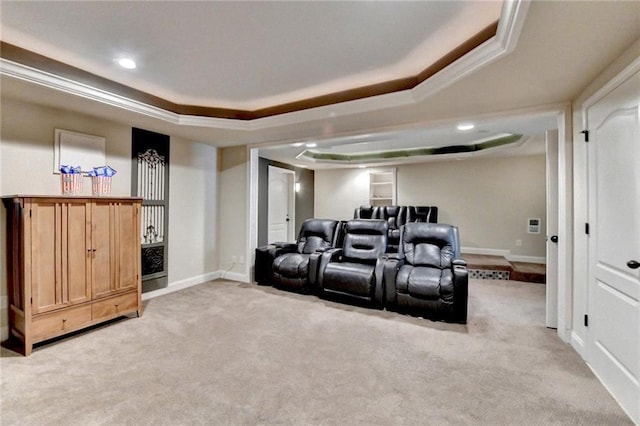 cinema room with a raised ceiling and light colored carpet