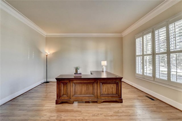 office space with ornamental molding and light wood-type flooring