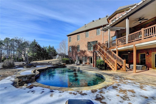 snow covered pool featuring a patio area, ceiling fan, and a wooden deck