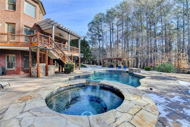 view of pool featuring a patio, ceiling fan, an in ground hot tub, and a pergola