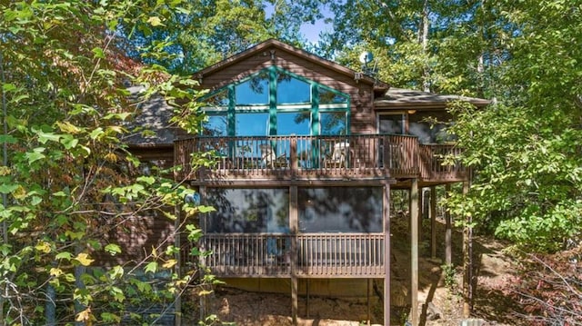 back of property featuring a sunroom and a deck