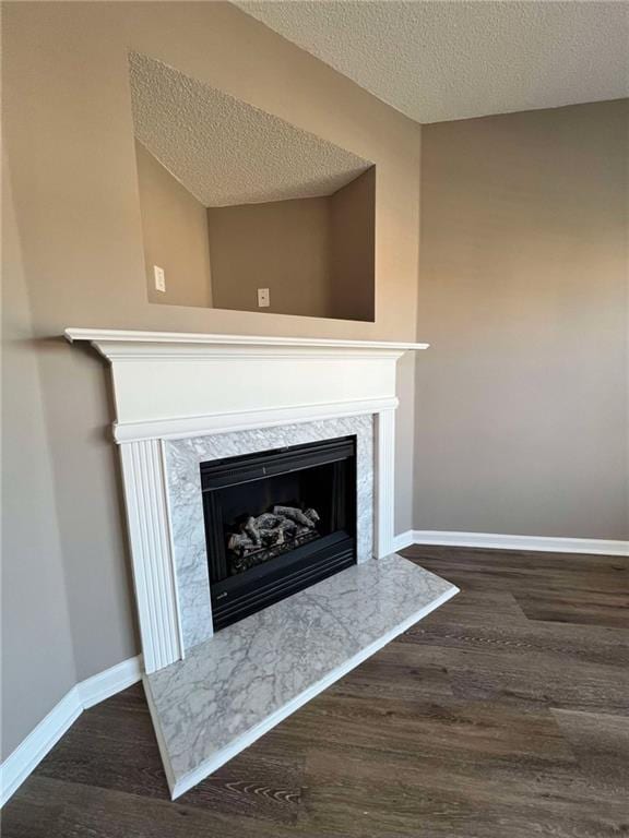 room details featuring a fireplace, hardwood / wood-style floors, and a textured ceiling