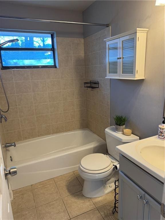 full bathroom featuring vanity, toilet, tile patterned floors, and tiled shower / bath combo