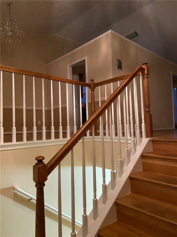 stairs featuring an inviting chandelier