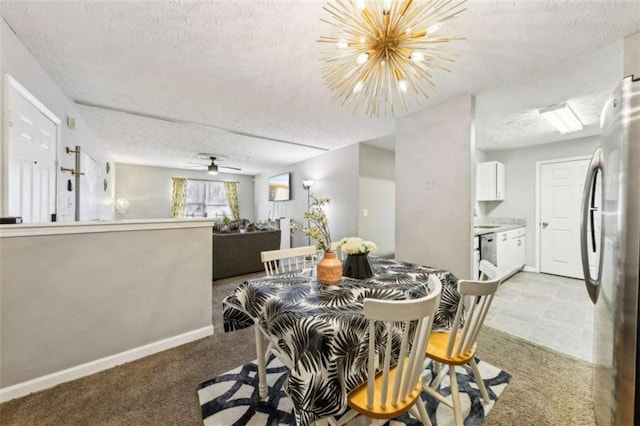 dining space with ceiling fan with notable chandelier, a textured ceiling, and light colored carpet