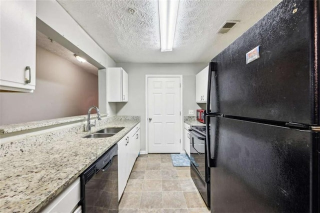 kitchen featuring light stone countertops, a textured ceiling, sink, black appliances, and white cabinets