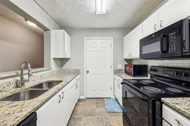 kitchen with white cabinets, sink, tasteful backsplash, and black appliances