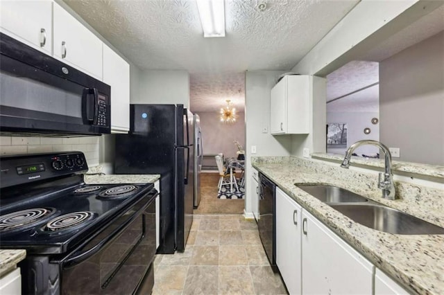 kitchen with backsplash, light stone counters, sink, black appliances, and white cabinets