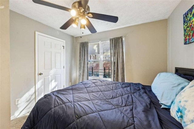 carpeted bedroom with a textured ceiling and ceiling fan