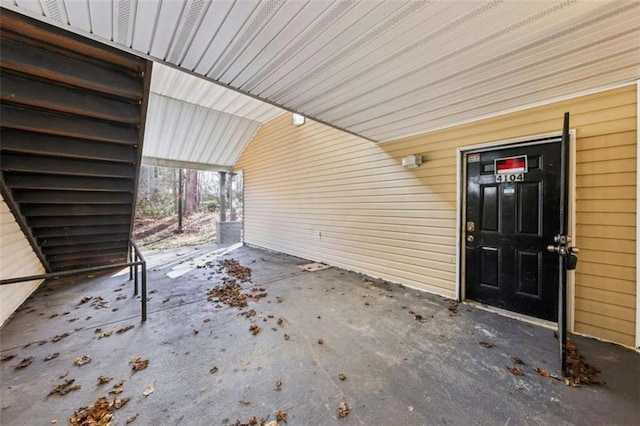 doorway to property featuring a carport