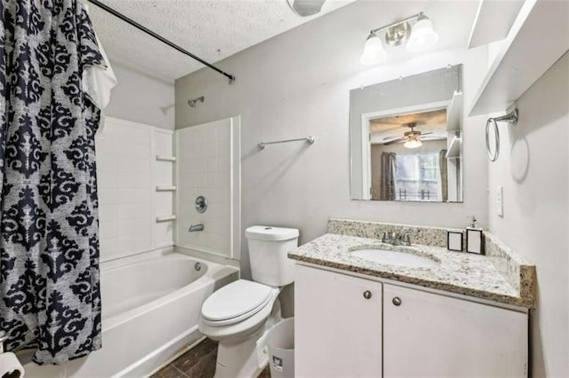 full bathroom with vanity, washtub / shower combination, ceiling fan, toilet, and a textured ceiling