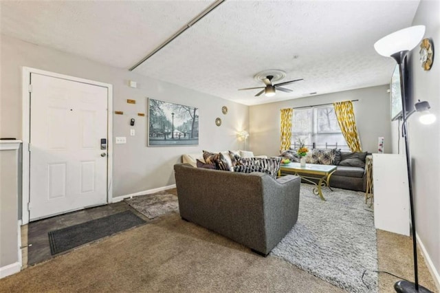 living room featuring a textured ceiling, carpet floors, and ceiling fan