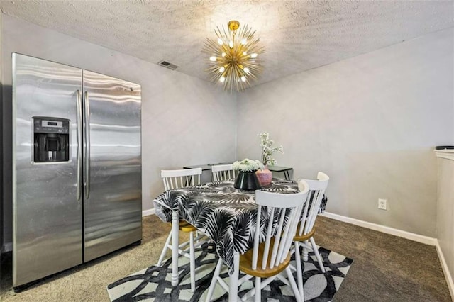 dining space with carpet flooring, a textured ceiling, and a notable chandelier