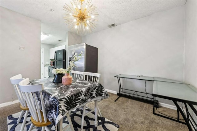 dining area with a notable chandelier, carpet floors, and a textured ceiling