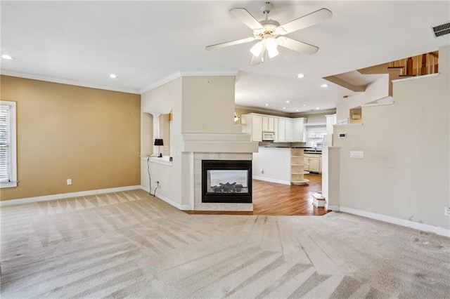 unfurnished living room featuring baseboards, light colored carpet, and ornamental molding