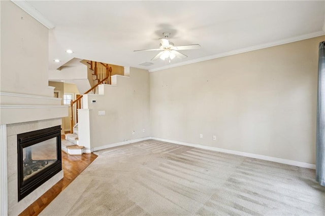 unfurnished living room with a multi sided fireplace, baseboards, ornamental molding, and stairs