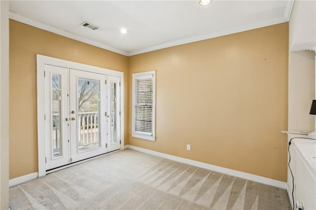 foyer entrance with crown molding, light colored carpet, and visible vents