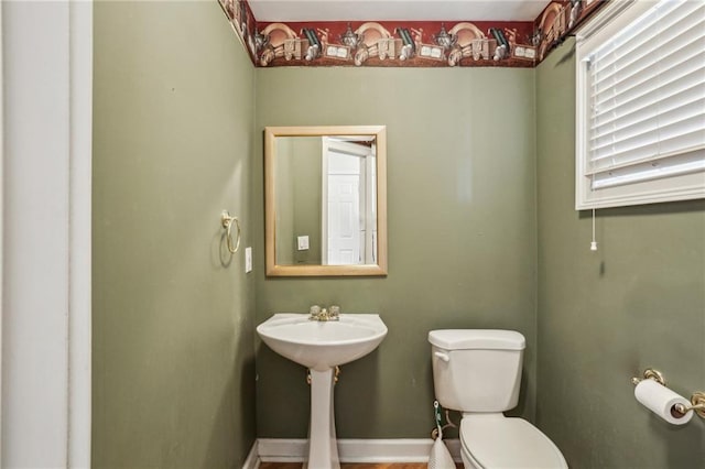 bathroom featuring toilet and baseboards