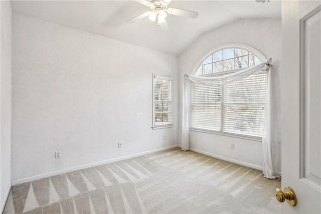 spare room with lofted ceiling, carpet, and a wealth of natural light