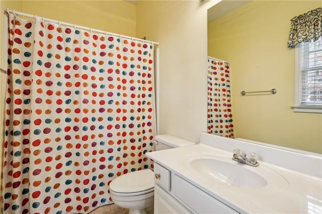 bathroom with a shower with shower curtain, toilet, and vanity