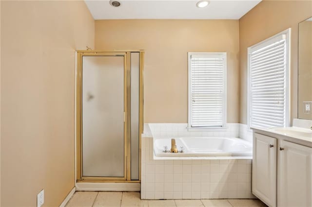 full bathroom with vanity, a shower stall, a bath, and tile patterned floors