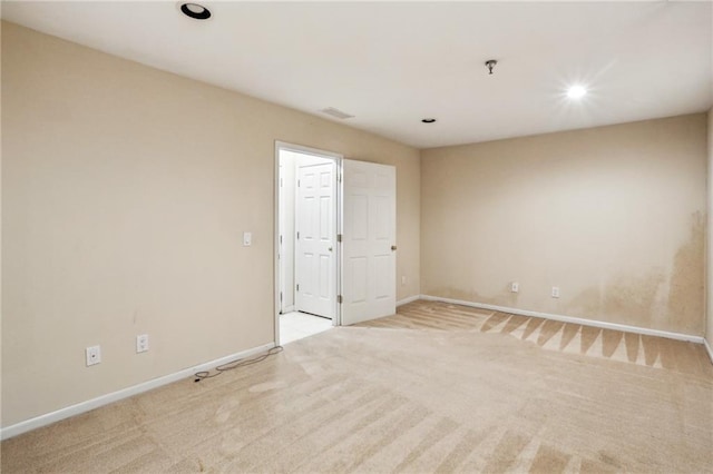 empty room with recessed lighting, baseboards, and light colored carpet