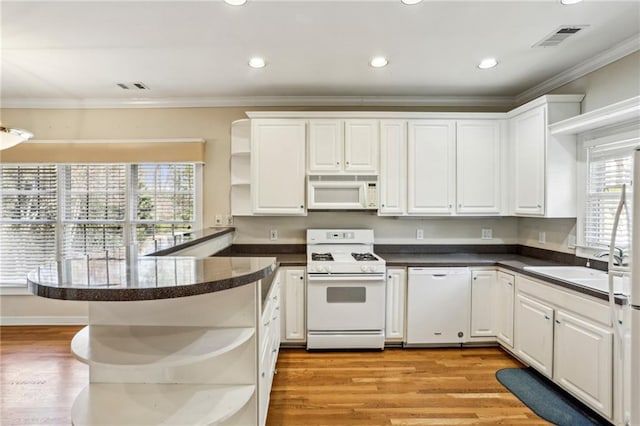 kitchen featuring visible vents, open shelves, white appliances, a peninsula, and crown molding