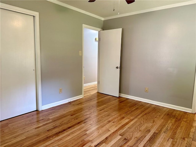 unfurnished bedroom with baseboards, ornamental molding, light wood-style flooring, and ceiling fan