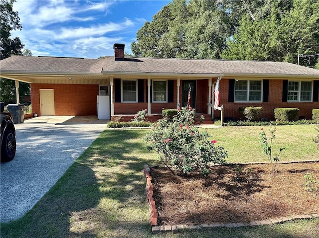 ranch-style home featuring brick siding, driveway, a chimney, and a carport