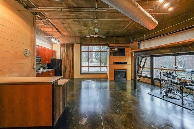 unfurnished living room featuring finished concrete flooring and a fireplace