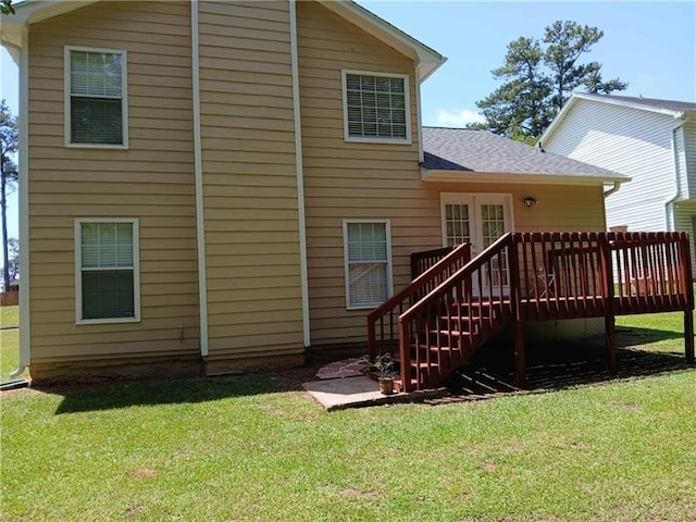 back of house featuring a wooden deck, stairway, a shingled roof, and a yard