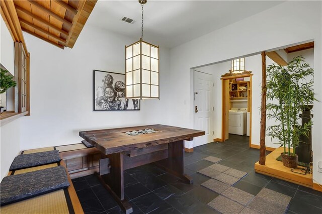 dining area featuring vaulted ceiling