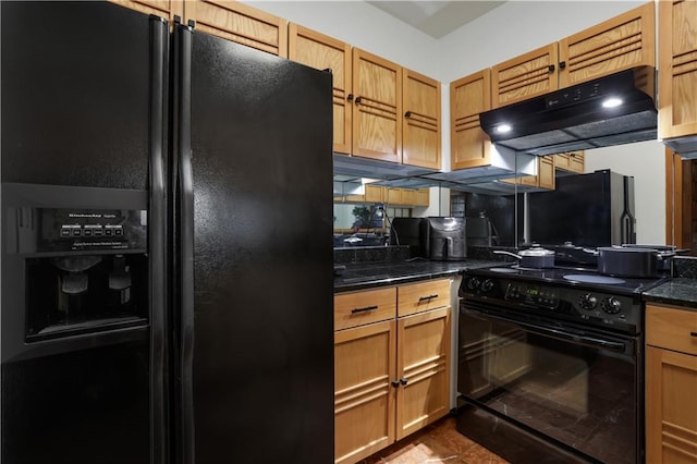 kitchen with dark stone countertops, black appliances, and tile patterned floors