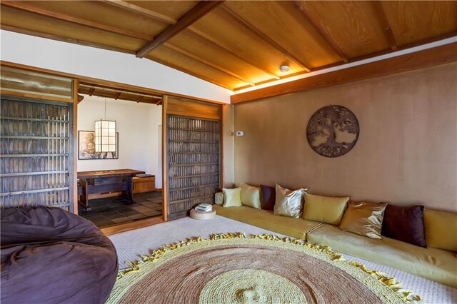 living room with lofted ceiling with beams