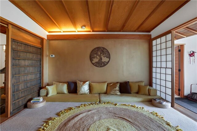 living room with wood ceiling, lofted ceiling, and built in features