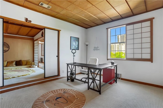 office space with wood ceiling and light colored carpet