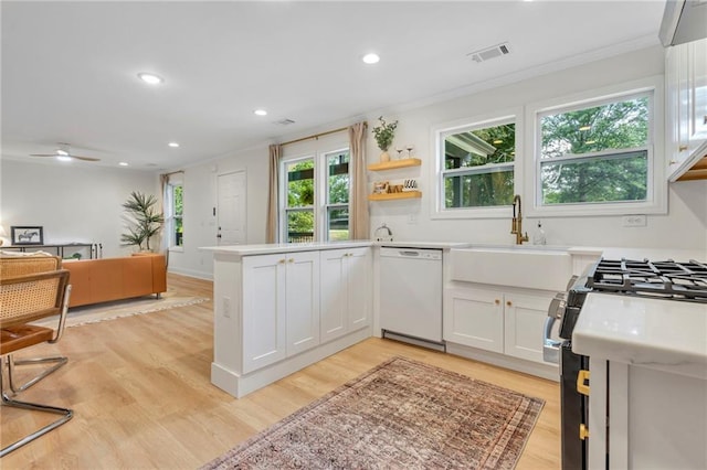 5601 Due W Rd, Powder Springs, GA 30127 - kitchen with white dishwasher, gas range, crown molding, a peninsula, and recessed lighting