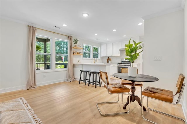 5601 Due W Rd, Powder Springs, GA 30127 - dining room with light wood-style floors, recessed lighting, and crown molding